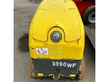 a yellow machine that is sitting in the dirt