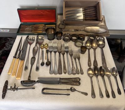 beaucoup d'argenterie sur une table où se trouve une boîte rouge