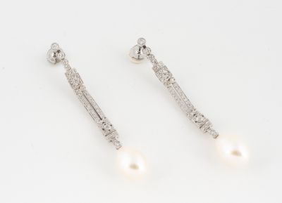 a pair of pearl and diamond earrings