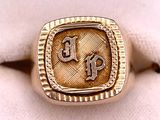 an image of a gold ring with initials on it