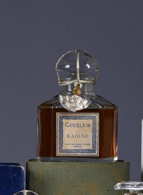 a bottle of perfume sitting on a table next to other bottles