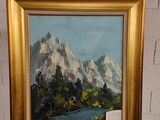 un tableau représentant un paysage de montagne, dans un cadre doré