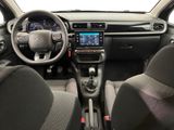 the interior of a small car with a steering wheel and dashboard