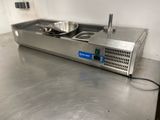 stainless steel counter top with a frying pan and a frying pan on it