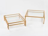 two glass and wood coffee tables on a white background