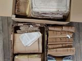 a box full of books and papers on a wooden floor