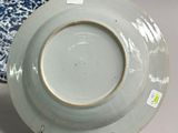 two plates and a bowl on display on a table