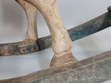 a wooden rocking horse that is sitting on a table