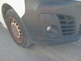 a close up of the front bumper of a white van