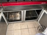 a red counter top oven with two racks of food inside of it