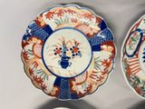 two plates with designs on them are sitting on a table
