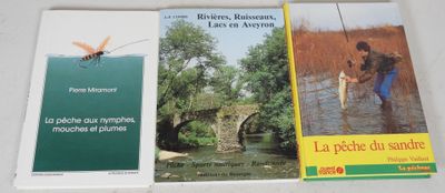 three books on a table with a man fishing