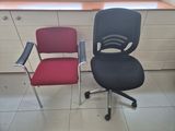 two office chairs sitting next to each other in a room