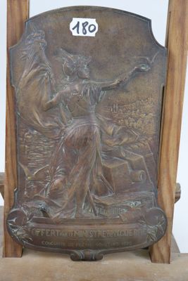 a bronze plaque of a woman on a chair