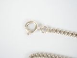 a silver chain that has a ring on it