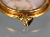 a gold ring with a picture of a woman on it
