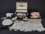 a box with lace, beads, and other items on a table