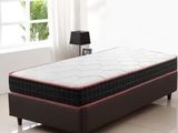 a bed that has a mattress on it in a room