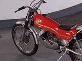a red motorcycle that is parked in a garage