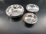 three silver bowls sitting on top of a table next to each other