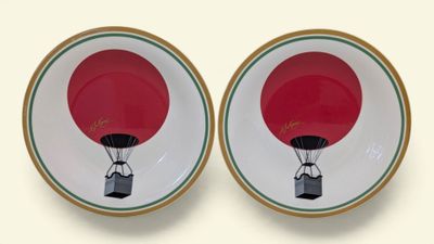 two plates with a red hot air balloon on them