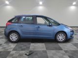 the blue car is parked in the garage on a checkered floor