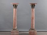 pair of pink marble pedestals with black marble bases