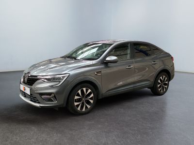 a grey car is parked in a room with a black floor