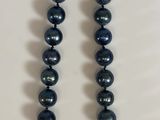 blue pearl necklace with a gold clasp on a white background