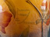 an image of a vase with oranges and leaves painted on it