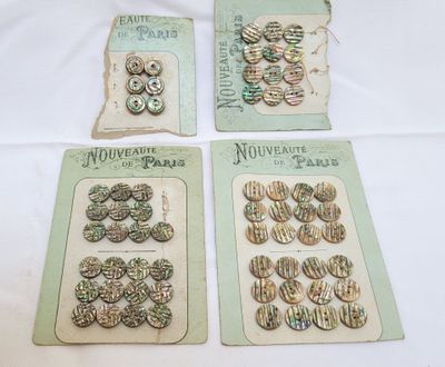 four vintage broochee buttons are displayed on a table