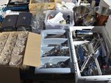 a lot of silverware on a table in a room