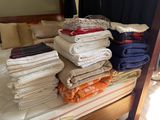a bed with a bunch of folded towels on it