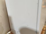 a white refrigerator sitting on a pallet in a warehouse