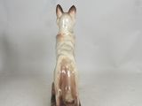 a figurine of a dog sitting on top of a table