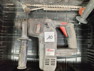 a drill and a hammer in a black container