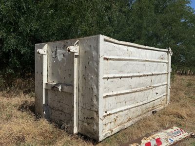 une boîte blanche posée au milieu d'un champ