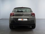 the back of a grey citrole parked in a white room
