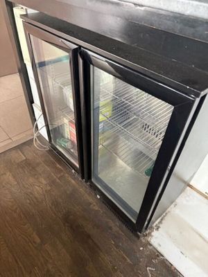un réfrigérateur muni de deux portes vitrées qui sont ouvertes