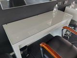 a white table with a mirror on it in a room