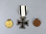 two medals and a coin are sitting on a table