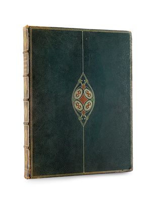 an old green book with a decorative design on the cover