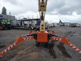 a crane that is sitting in the middle of a parking lot