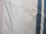 a blue and white striped pillow on a bed