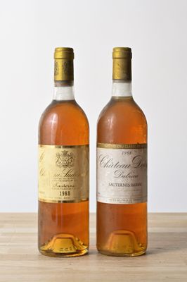 two bottles of wine that are sitting on a table