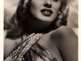 an old black and white photo of a woman in a dress