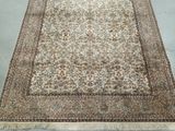 an oriental rug with a floral design and fringes on it