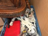 a blue container filled with assorted items next to a wooden chair