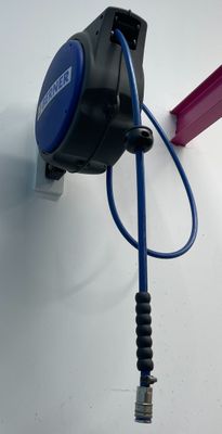 a blue cord attached to a wall with a pink handle