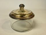an image of a glass jar with a gold lid on a white surface
